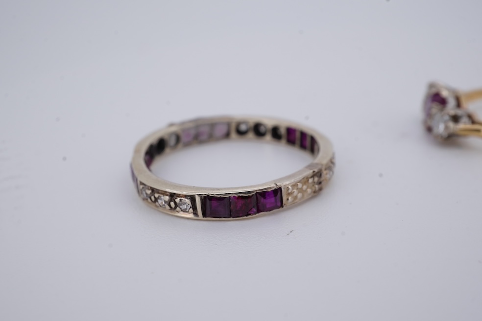 A yellow metal, stamped 18ct, ruby and diamond set three stone ring, size W, together with a yellow metal ruby and diamond set full eternity ring, size Q, gross weight 4.4 grams. Condition - poor to fair